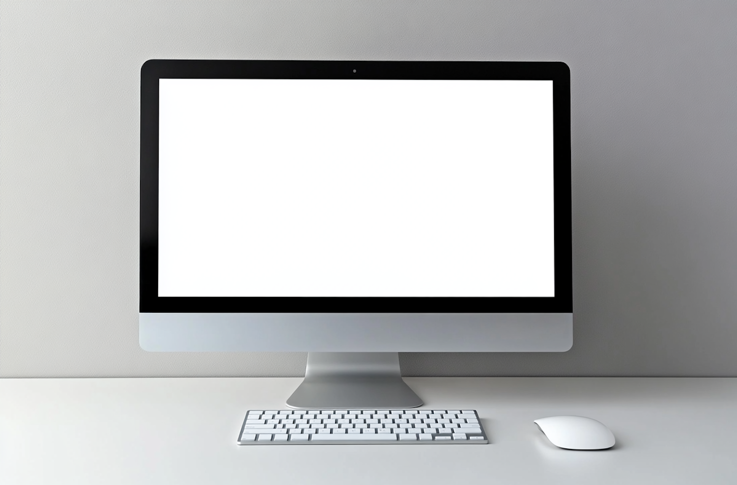 Desktop monitor and keyboard on a clean studio desk